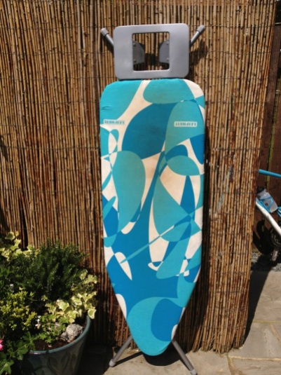 Old stained ironing board cover